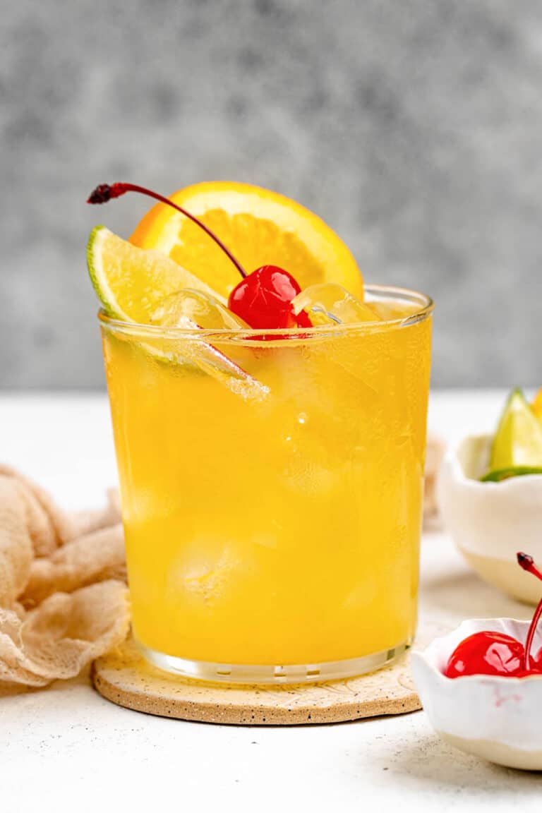 Copycat Applebee's white peach sangria garnished with orange, lime, and a cherry.