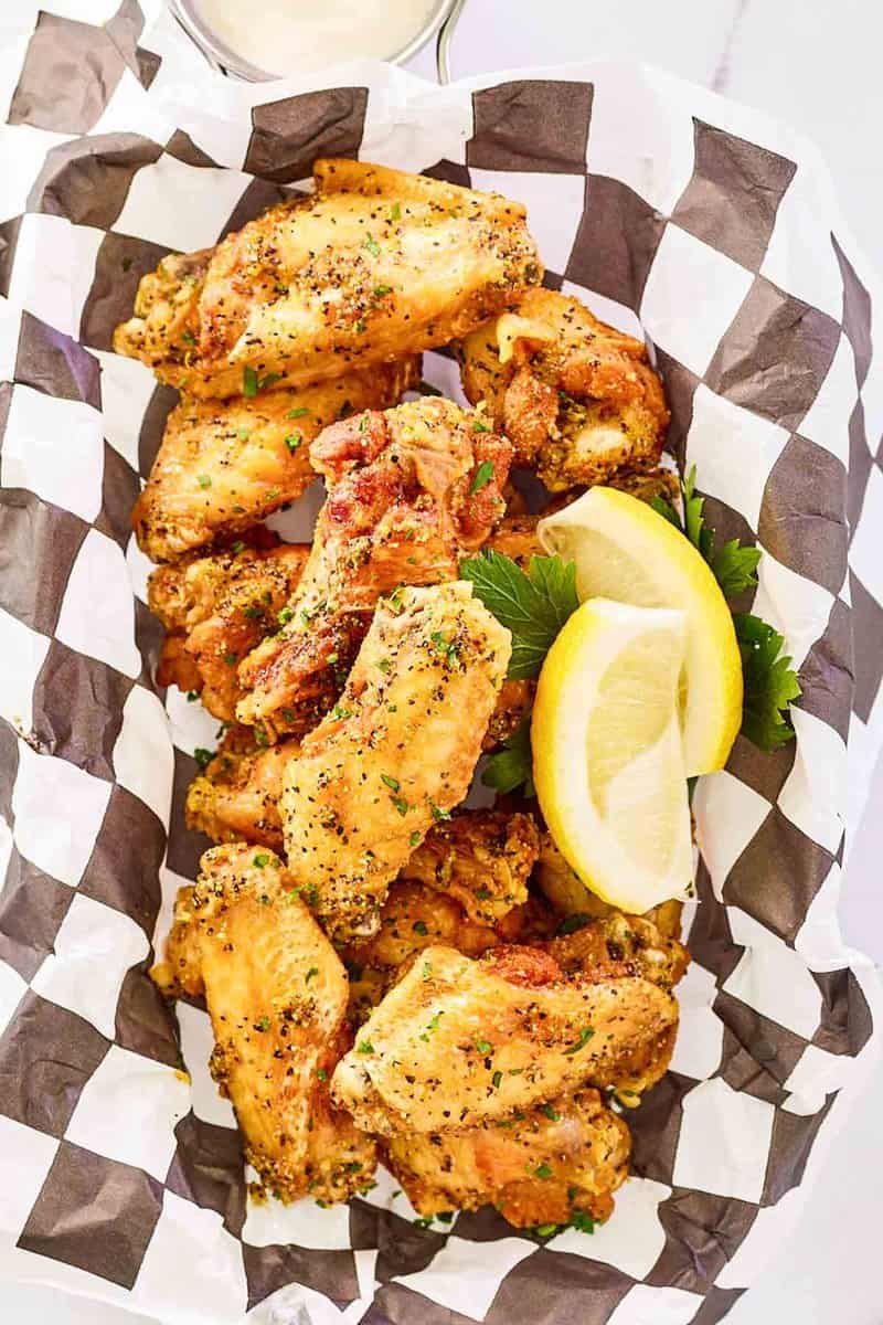 Overhead view of copycat Buffalo Wild Wings lemon pepper wings in a serving basket.