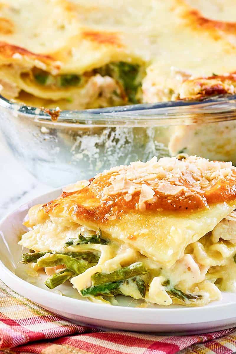 Chicken lasagna with asparagus on a plate and in a baking dish.