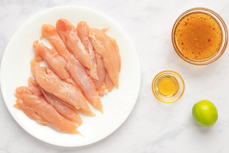 Copycat Cracker Barrel grilled chicken tenders ingredients on a marble surface.