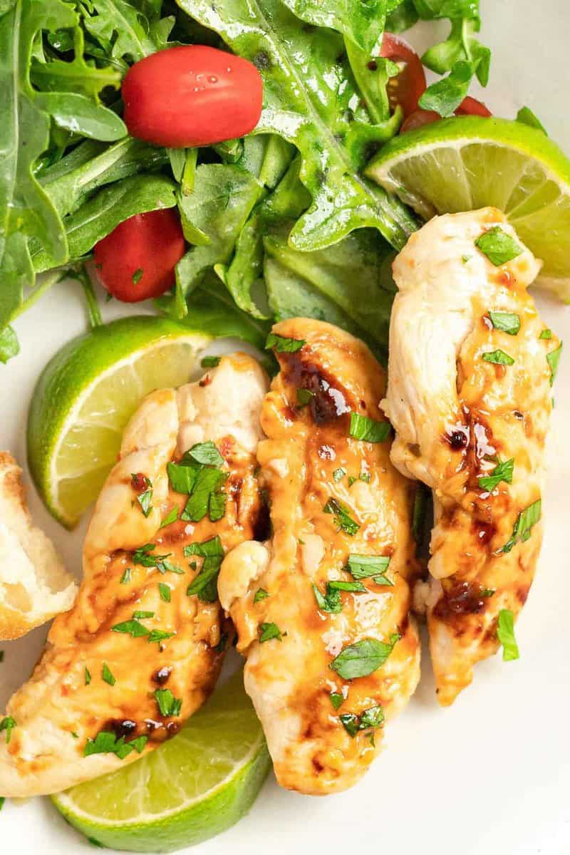 Copycat Cracker Barrel grilled chicken tenders and a salad on a plate.