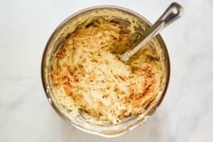 Hashbrown casserole mixture in a mixing bowl.