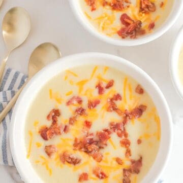 Overhead view of copycat La Madeline country potato soup in two bowls.