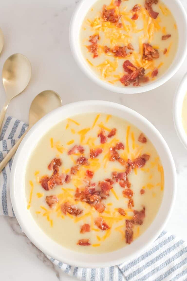 Overhead view of copycat La Madeline country potato soup in two bowls.