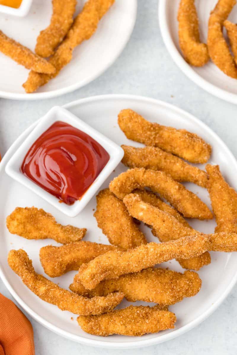 Copycat Burger King chicken fries and a small cup of ketchup on a plate.