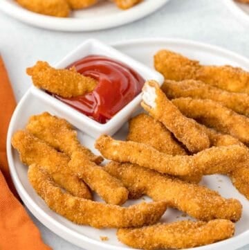 Copycat Burger King chicken fries and a small cup of ketchup on a plate.