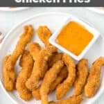 Homemade Burger King chicken fries and a cup of dipping sauce on a plate.
