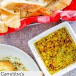 Copycat Carrabba's bread dip in a bowl and bread slices in a basket.
