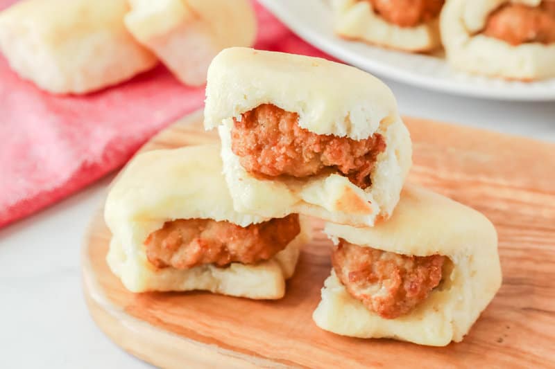 Three copycat Chick Fil A chicken minis on a wood cutting board.