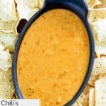 Homemade Chili's skillet queso dip surrounded with tortilla chips.