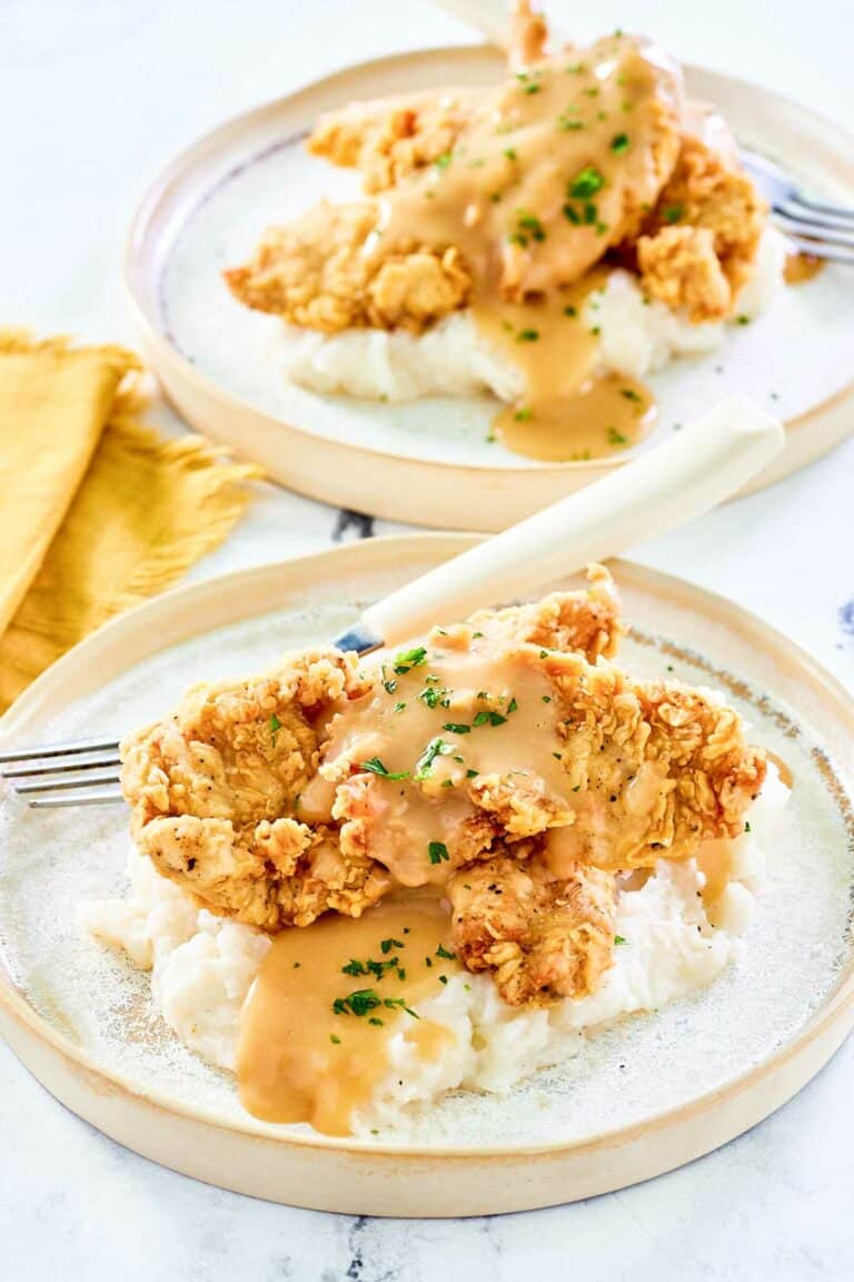 Copycat Cracker Barrel fried chicken tenders on two plates.