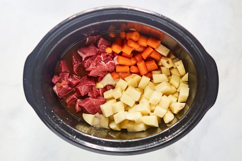 Beef stew ingredients in a crockpot.