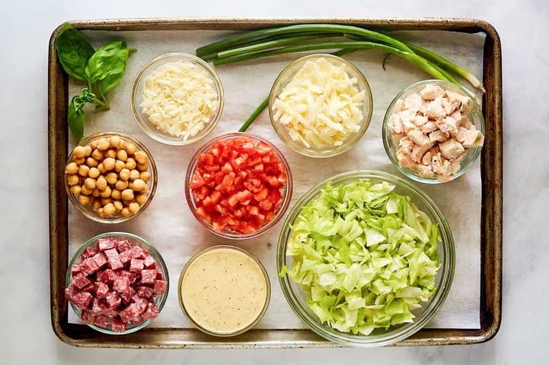 Copycat Cucina Cucina chopped salad ingredients on a tray.