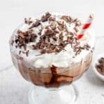 Frozen hot chocolate in a dessert dish topped with whipped cream and chocolate shavings.
