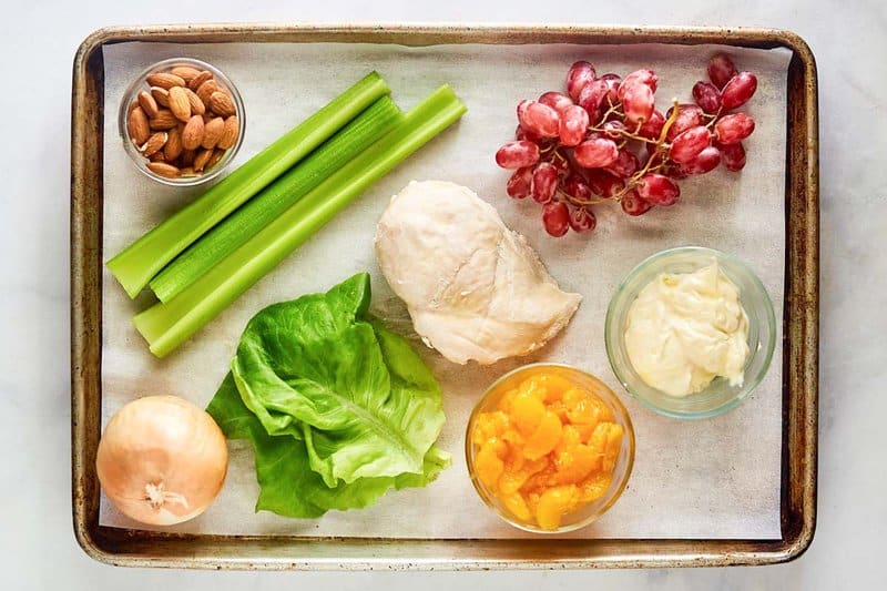 Fruity chicken salad ingredients on a tray.