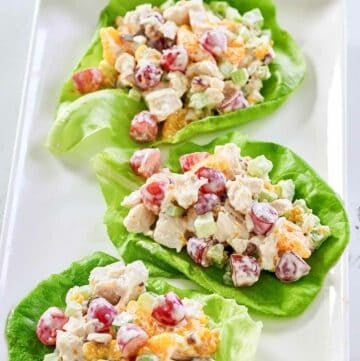 Fruity chicken salad with grapes, mandarin oranges, and nuts on a platter.