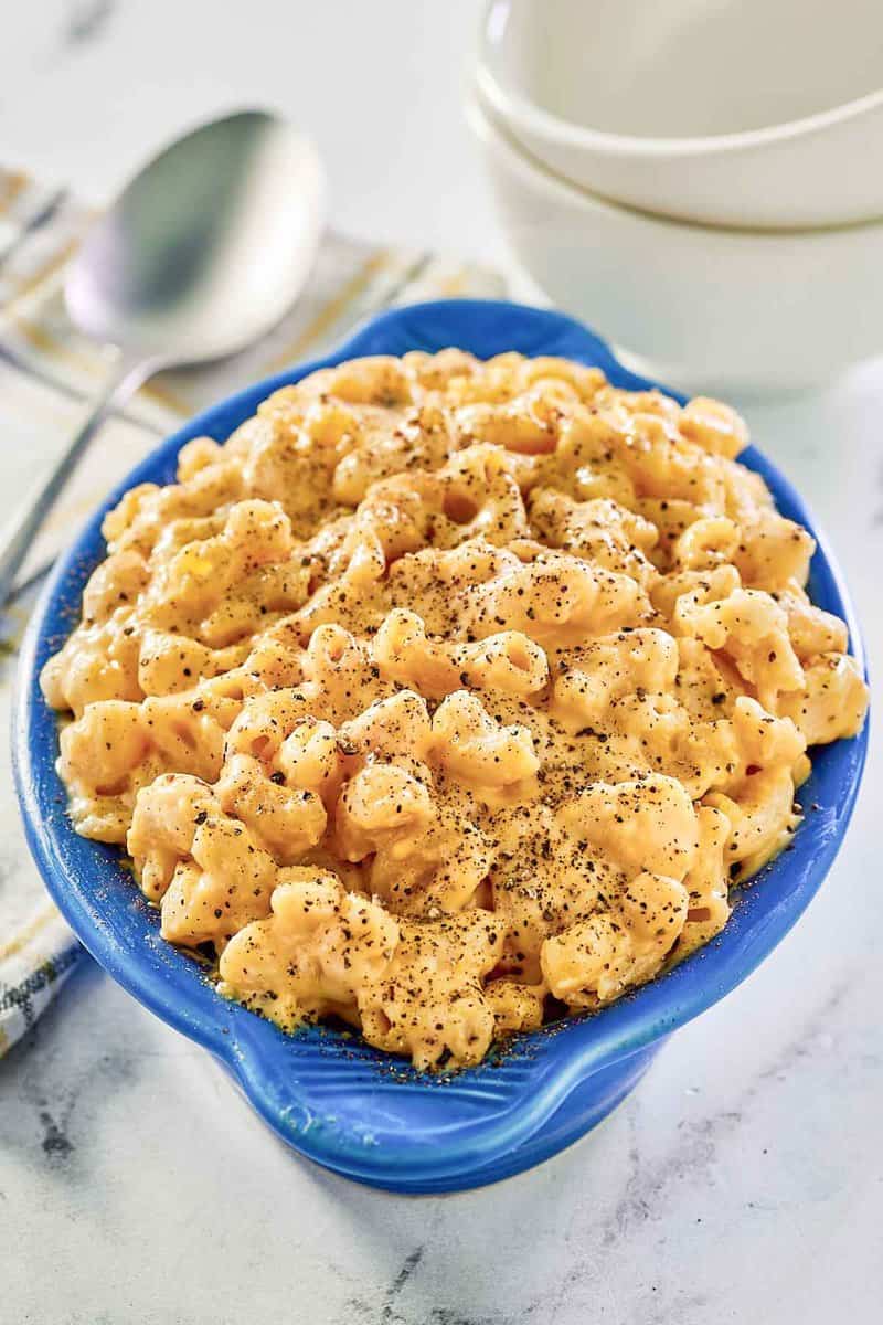 Homemade macaroni and cheese in a ceramic serving dish.