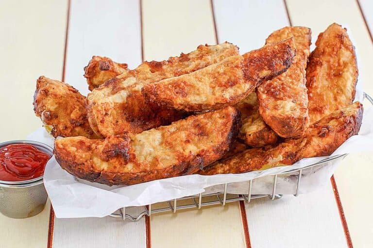 Thick potato wedges fried until crisp.