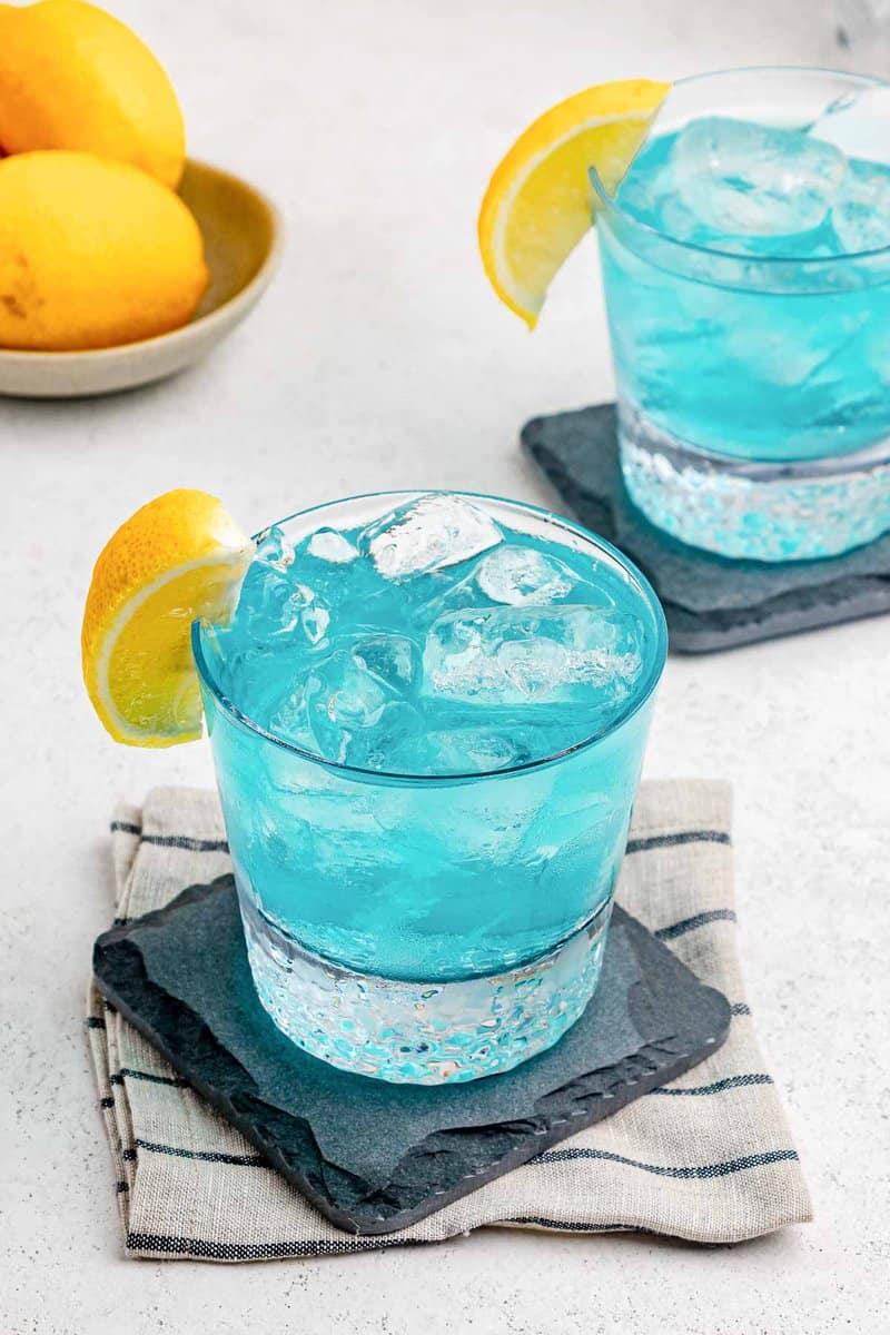 Two copycat Olive Garden Blue Amalfi drinks on coasters.