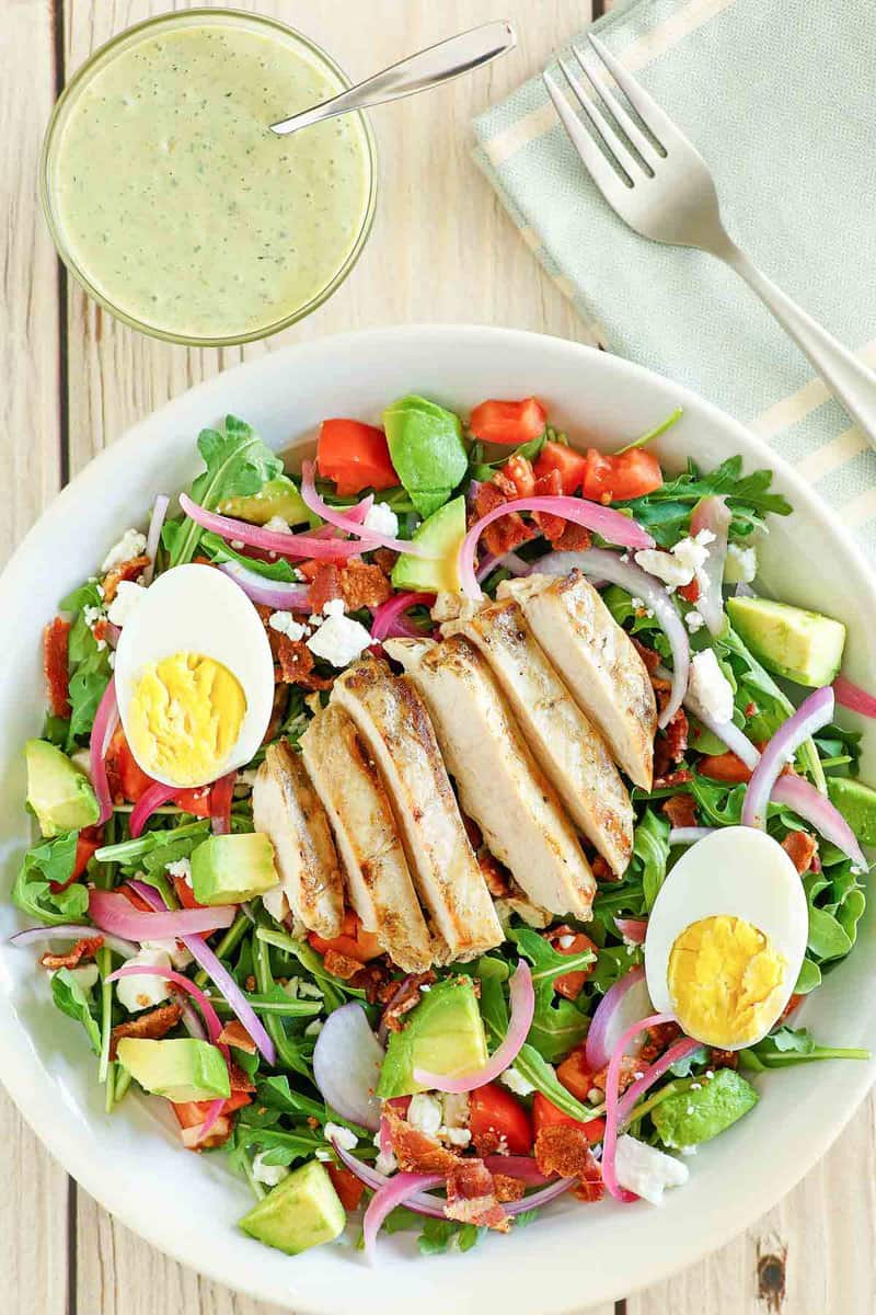 Copycat Panera chicken cobb salad and a bowl of green goddess dressing.