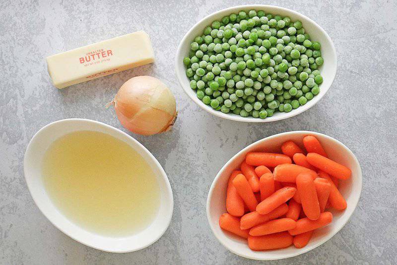 Buttery peas and carrots ingredients connected  a marble surface.