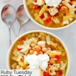Two bowls of homemade Ruby Tuesday white chicken chili garnished with sour cream.