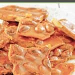 Homemade almond brittle candy piled on a plate.