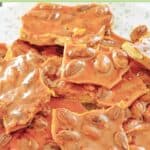 Pieces of almond brittle candy piled on a plate.