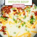 Homemade Bennigan's potato soup garnished with bacon, cheese, and green onions.