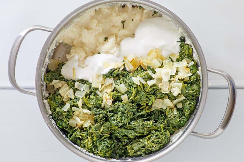 Copycat Boston Market creamed spinach ingredients in a pot.