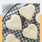 Heart-shaped cake mix cookies with butter on a wire cooling rack.