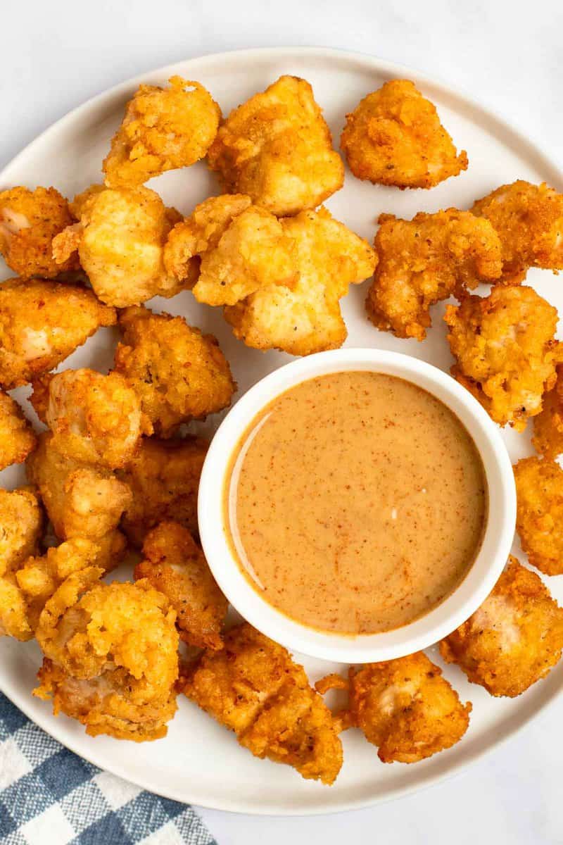 Copycat Chick Fil A chicken nuggets and dipping sauce on a plate.