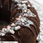 Chocolate peppermint bundt cake with ganache and crushed candies on top.