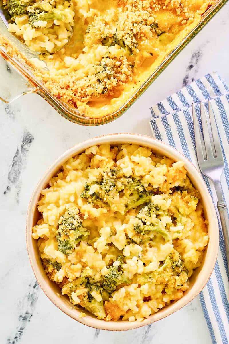 Copycat Cracker Barrel broccoli cheese casserole with rice in a bowl and baking dish.