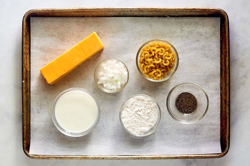 Homemade mac and cheese ingredients on a tray.
