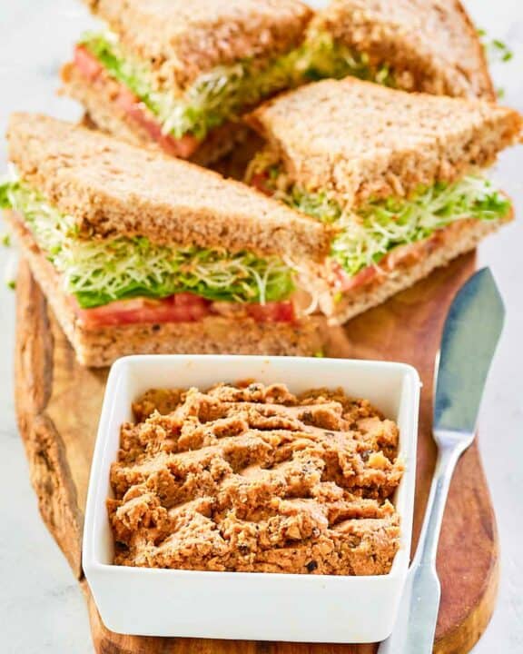 Sandwiches made with homemade Loma Linda sandwich spread and a bowl of the spread.