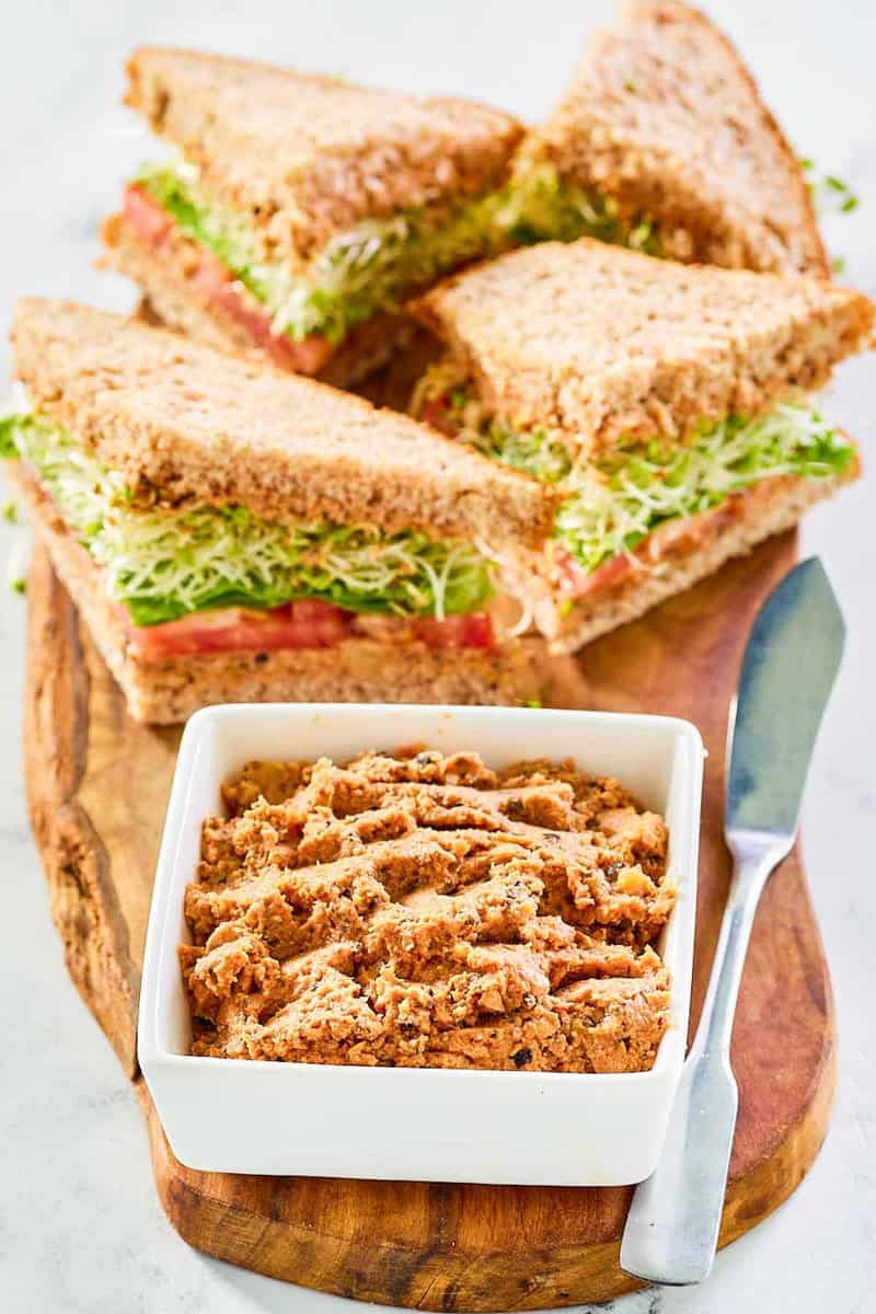 Sandwiches made with homemade Loma Linda sandwich spread and a bowl of the spread.