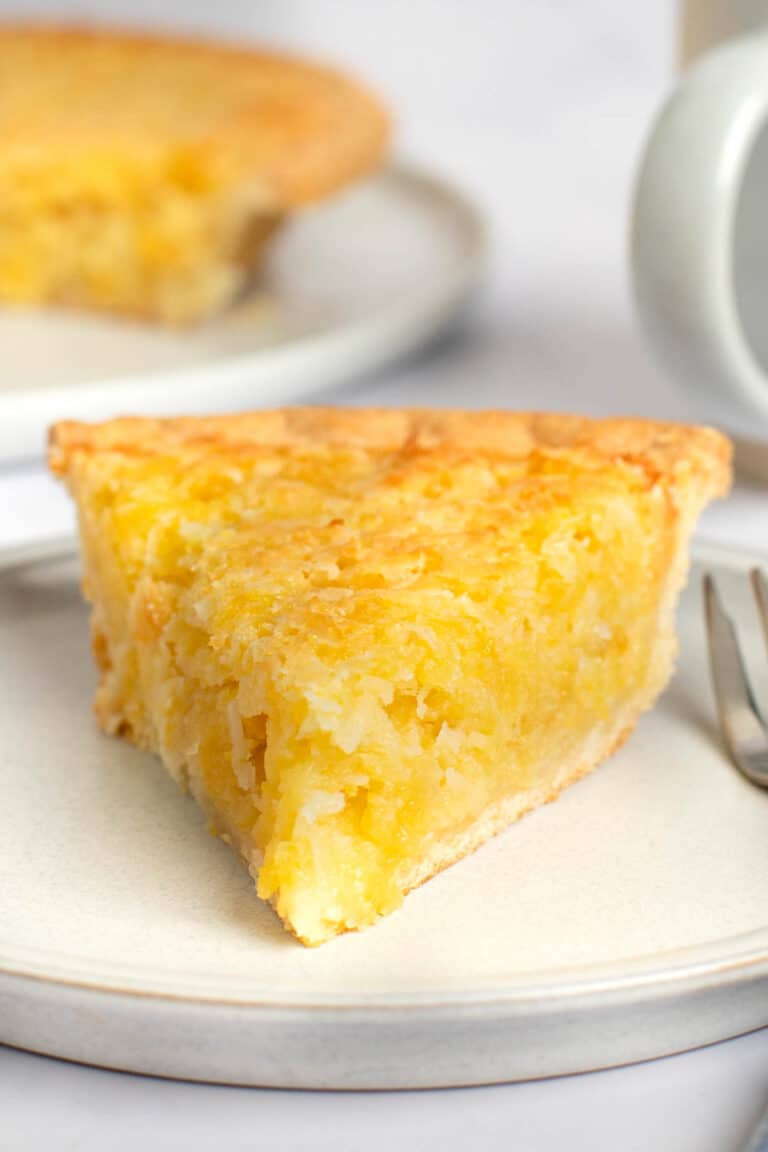 Copycat Luby's Hawaiian pie slice on a plate and the pie behind it.