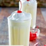 Homemade McDonald's eggnog shakes with whipped cream and a cherry on top.