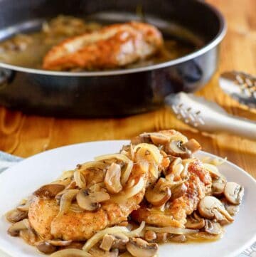 Copycat Olive Garden chicken marsala on a plate and in a skillet.