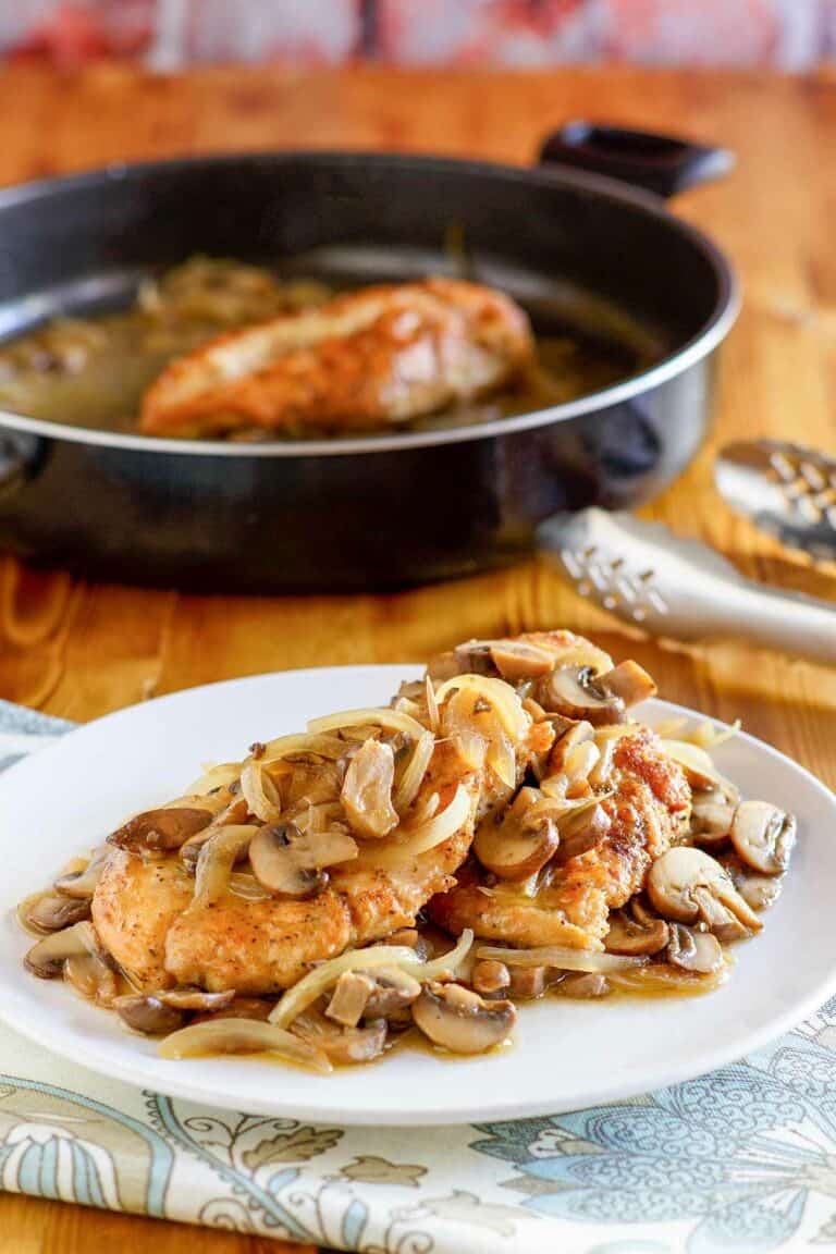 Copycat Olive Garden chicken marsala on a plate and in a skillet.