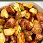 Oven roasted red potatoes with chopped fresh parsley sprinkled on top.