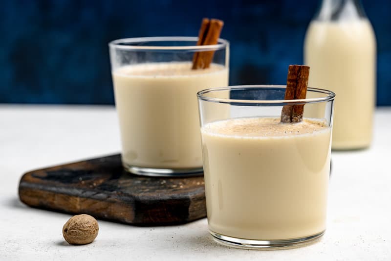 Homemade spiked eggnog in cocktail glasses.