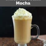 Homemade Starbucks white chocolate mocha latte in a glass coffee mug.