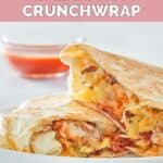 Copycat Taco Bell breakfast crunchwrap and a bowl of taco sauce.