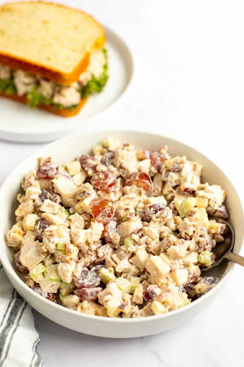 A bowl of copycat Arby's pecan chicken salad with grapes and apples.