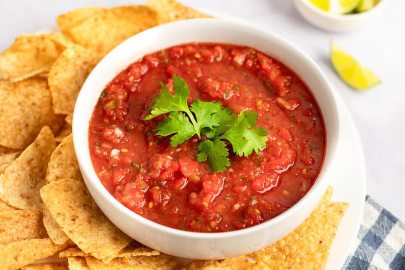 Copycat Chili's salsa and corn tortilla chips on a platter.