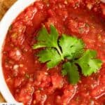 A bowl of homemade Chili's salsa garnished with fresh cilantro.