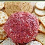 Dried beef cheese ball and crackers on a platter.