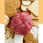 Dried beef cheese ball and assorted crackers around it.